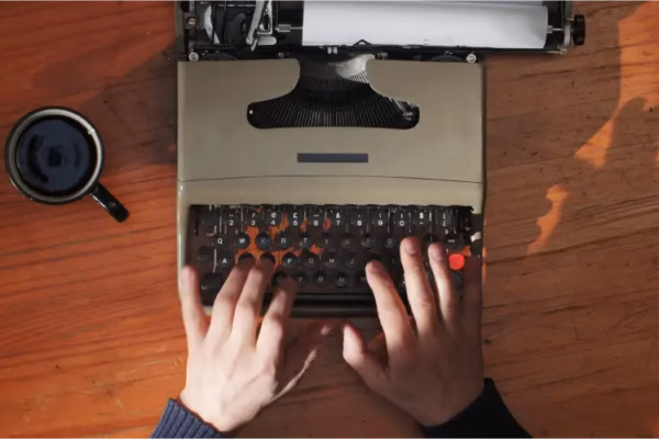 writing a video script with a vintage typewriter